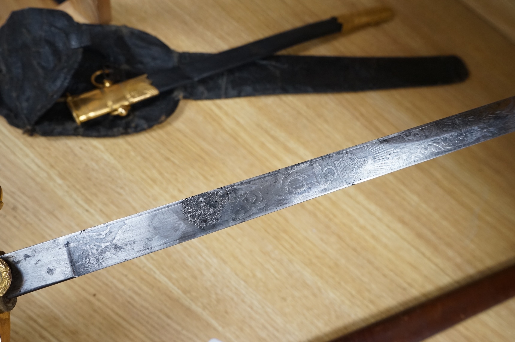 A post 1902 regulation Naval Officer’s dirk with lion’s head pommel, bullion dress knot, shark skin covered grip, in its leather scabbard, the gilt locket engraved with owners initials; CHCO’ R, the blade etched with cro